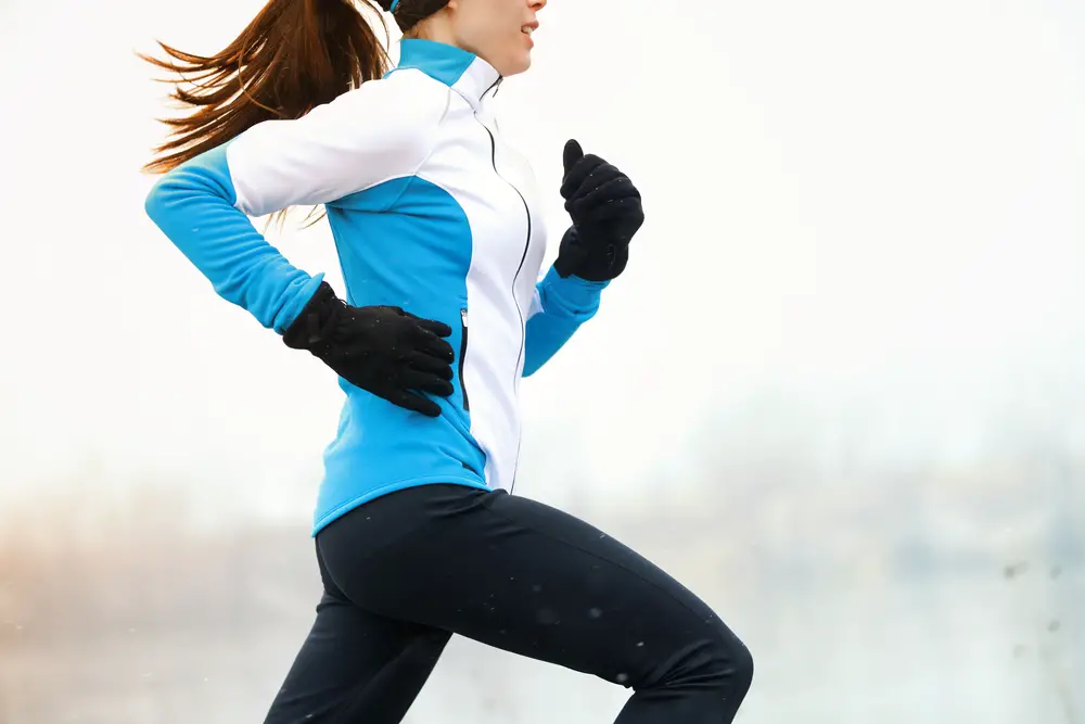 Running,Athlete,Woman,Sprinting,During,Winter,Training,Outside,In,Cold